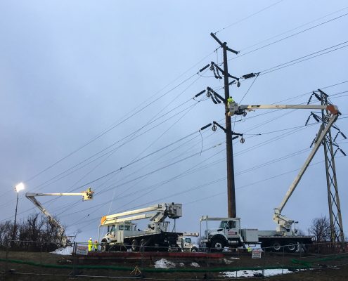 NEAT outside lineman fixing transmission lines