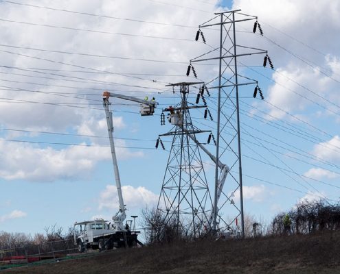 Outside lineman work on high-voltage system