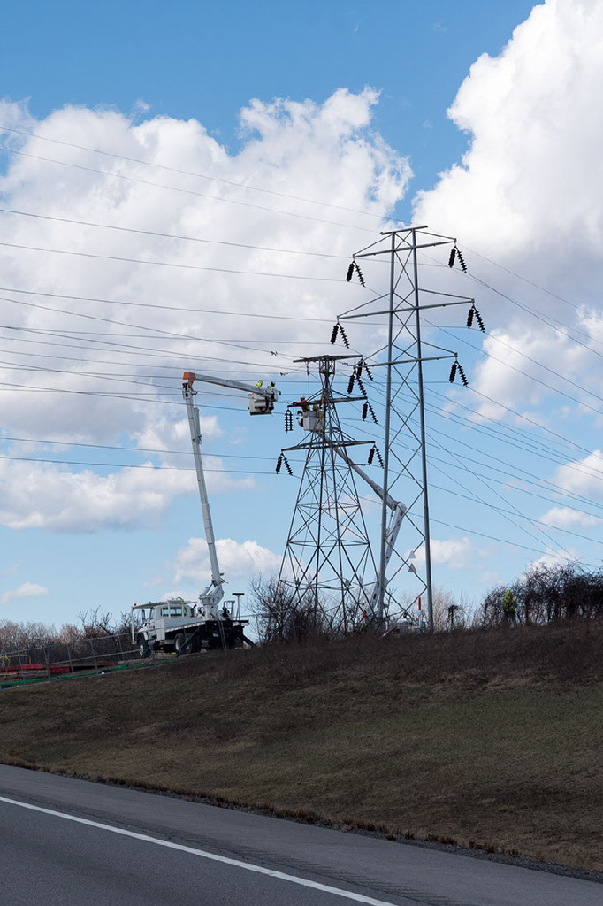 Outside lineman work on high-voltage system