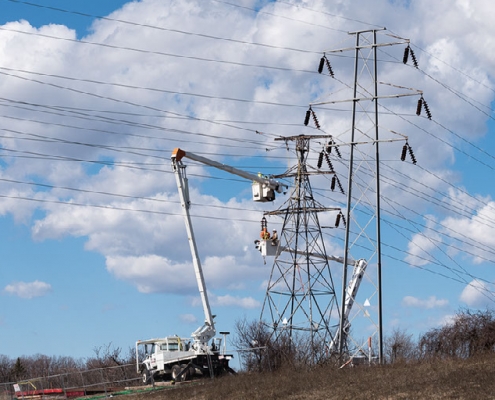 NEAT apprentices in buckets to work on high-voltage work